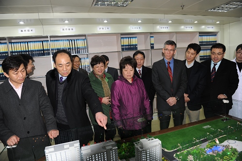 张建平院长向县委书记单晓鸣和肿瘤专家介绍医院全貌沙盘